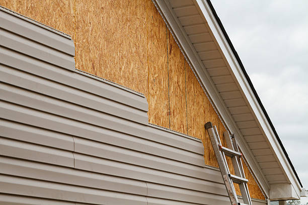 Professional Siding Installation technician working in Brookville, NY
